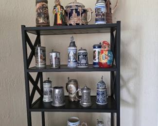 Black metal shelf with collectible beer steins and mugs