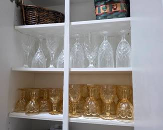 White shelving with clear and amber glassware