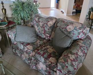 Floral upholstered loveseat with glass side table