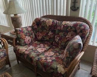 Floral cushion rattan loveseat with lamp and side table