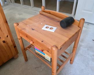 Pine nightstand with lower shelf and books