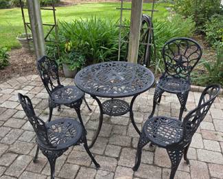 Cast aluminum patio set with round table and four chairs