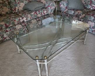 Glass-top coffee table with floral sofas and area rug