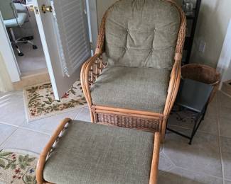 Rattan chair and ottoman set with metal display shelf behind