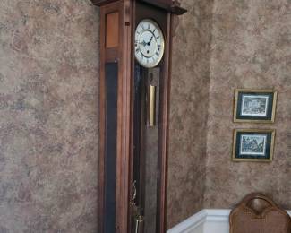 Walnut-finish wall clock with pendulum and framed prints