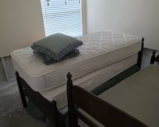 Bedroom with twin bed, dark wood frame and curtain valance