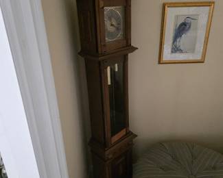 Walnut-finish grandfather clock with framed print