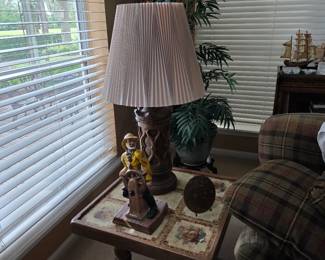 Table lamp on wood end table with decor and plaid chair