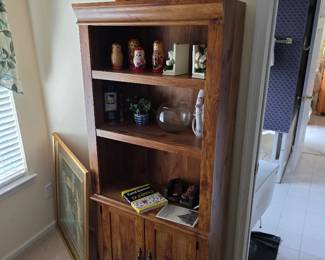 Pine bookcase with cabinet doors and decorative items