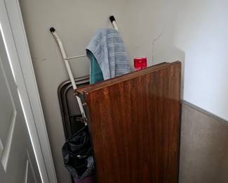 Closet with wood panel, vacuum and household items