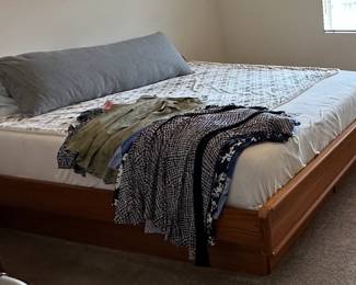 Photo of assembled King bed frame with Sleep Number mattress.  The bed is currently unassembled at the sale but available for sale. 