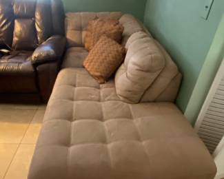 Sofa and pillows makes an L shaped with the other one