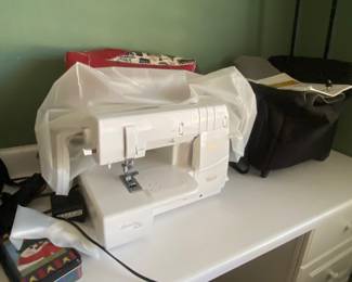Baby lock, sewing machine, splendid with cover and extra items, including rolling bag that holds the machine
