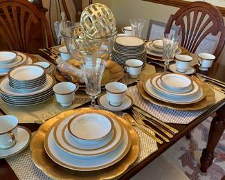 White dinner place setting with gold accent