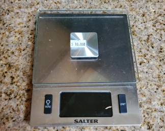 Salter brand digital kitchen scale with stainless steel top and plastic base. Features a digital display and appears to be in working condition.