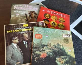 A collection of four vinyl records including titles related to Spanish music, early string instruments, and other genres. Records appear to be from the 1960s-1970s era based on cover design and styling.