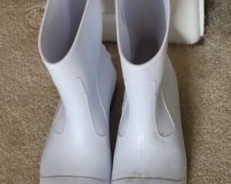 Pair of white rubber slip-on rain boots with a smooth finish. Suitable for wet weather wear.