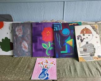 Collection of decorative pillows and fabric pieces in various colors and patterns, including floral, geometric, and abstract designs. Mix of materials and styles suitable for home décor.