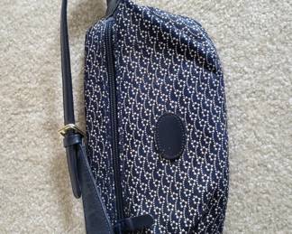 Navy blue crossbody bag with Michael Kors signature monogram pattern and adjustable shoulder strap. Shows normal wear consistent with regular use.