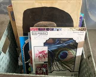 A collection of vinyl records stored in a bin, including various albums and a black record storage box. The lot contains multiple records spanning different genres and eras.