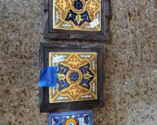 Set of three decorative tiles with blue and gold geometric patterns, mounted in dark wooden frames. The tiles feature traditional Spanish or Portuguese-style designs with ornate detailing.