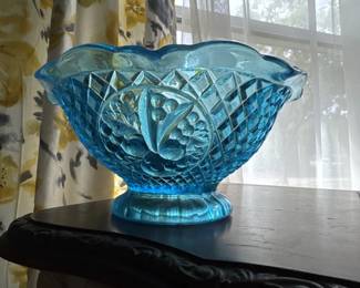 Vintage blue pressed glass bowl featuring a quilted diamond pattern and scalloped rim, mounted on a pedestal foot. The piece shows the characteristic color and design typical of mid-20th century glassware.