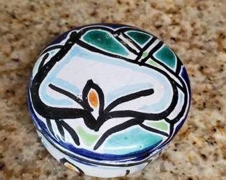 Small ceramic bowl featuring a hand-painted abstract design in blue, green, and black on a white background. The piece has a modern artistic style with geometric and organic elements.