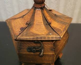 Early 20th century wooden box with a pyramidal lid and decorative leather straps with metal hardware. The piece shows warm wood grain and appears to be handcrafted in the Arts and Crafts style.