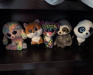 Set of five small Ty Beanie Boos plush animals with large eyes, including colorful and patterned designs. These collectible stuffed toys are in good condition.
