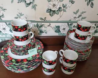 Complete dinnerware service featuring Pfaltzgraff's Winterberry pattern with holly and berry motifs on white ceramic. Set includes dinner plates, salad plates, bowls, cups, and saucers.