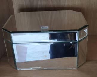 Mid-century modern style box with a chrome or stainless steel frame and clear glass panels on the sides and front. The top appears to be brushed metal with a minimalist design.