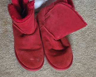 Pair of red suede boots with a fold-over cuff design. The boots show moderate wear and appear to be in used condition.