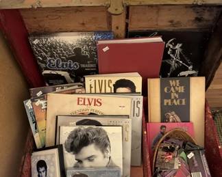 Lot of Elvis Presley collectibles including vinyl records, books, photographs, and merchandise. Items appear to span multiple decades of Elvis fandom.