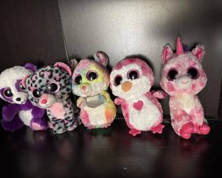 Collection of five Ty Beanie Boos stuffed animals in various colors and designs, including owl and cat styles with characteristic large eyes. Typical wear consistent with play or display.