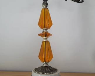 Table lamp featuring two stacked amber-colored glass teardrop-shaped shades separated by a metal band, mounted on a white marble base with ornate metal detailing. Includes cord and appears to be in working condition.