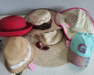 Collection of six hats including straw sun hats, a red wool hat, a striped wide-brim hat, and a turquoise baseball cap. Various styles and conditions suitable for casual wear or costume use.