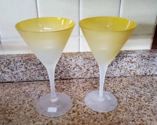 Two matching martini or cocktail glasses with yellow frosted bowls and clear frosted stems. Classic mid-century barware style.
