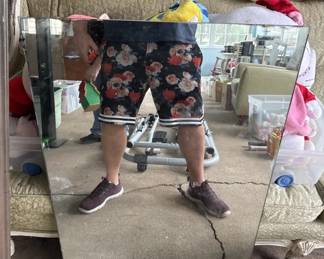 Black shorts with red floral print and white striping at the waist and leg openings. Casual summer wear in good condition.