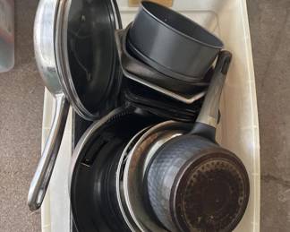 A collection of camera lenses and protective caps, including what appears to be telephoto and standard lenses with various metal and glass elements. The lenses show age-appropriate patina and wear consistent with vintage photography equipment.