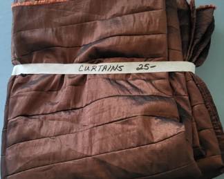 Pair of brown fabric curtains with horizontal quilted or textured detailing. Bundled together with a price tag indicating $25.