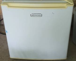 Vintage Emerson compact refrigerator with white exterior and harvest gold trim. Unit appears to be in working condition with minimal visible wear.
