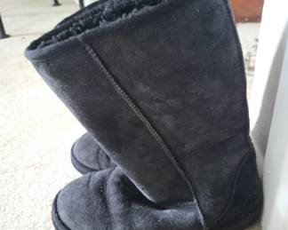 Black suede pull-on boot with fleece lining, featuring a side seam and cushioned sole. Shows moderate wear and creasing consistent with regular use.