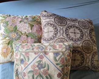 Set of three upholstered throw pillows featuring traditional floral and geometric designs in muted tones. The pillows display various patterns including botanical prints and ornamental motifs typical of classic home décor.