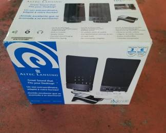 A pair of black Altec Lansing powered desktop speakers with built-in amplification, designed for computer audio output. The original retail packaging is visible.