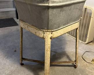 Antique galvanized washtubs on stands.