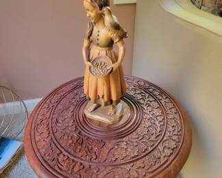 Hand carved girl with bird and table