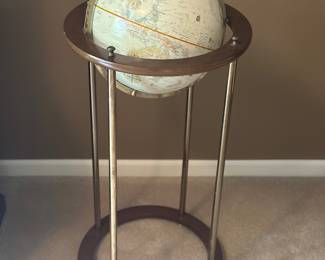 vintage floor-standing world globe on a mid-century modern style base