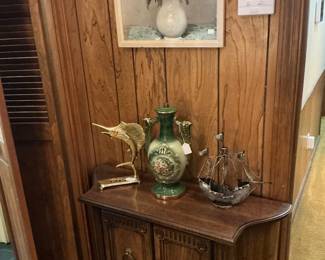 Another small credenza, a brass swordfish, attend ship, and colored vase