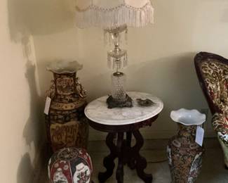 Simple floor vases one is a Japanese tile Satsuma a covered Ginger jar there are a pair of crystal lamps on marble top end tables