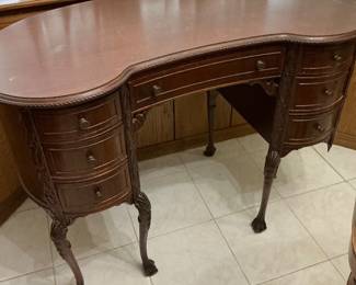 The kidney shaped desk sold as is. Has been repaired several times.